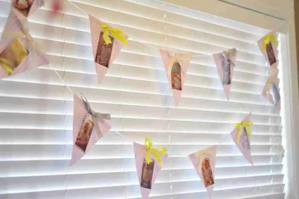 banner with baby pictures on a window.