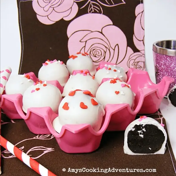 white cookie balls in a pink tray.