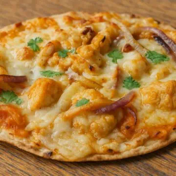 buffalo chicken tortilla pizza on a wooden table.