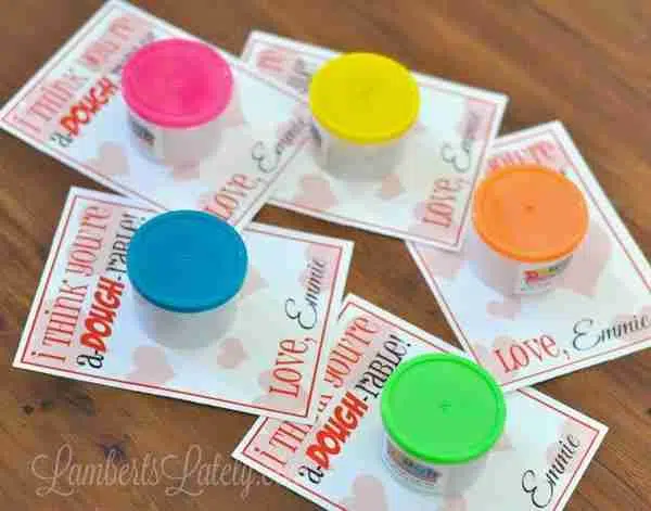 Free Printable Valentines for Play-Dough on a wood table.
