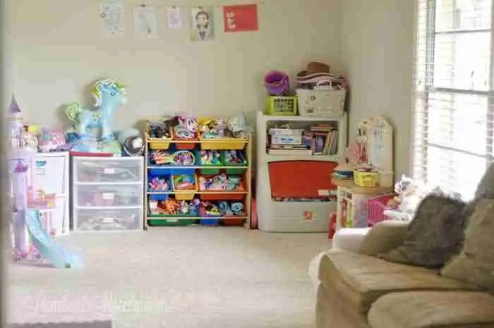 looking into playroom area with toys organized into plastic containers.
