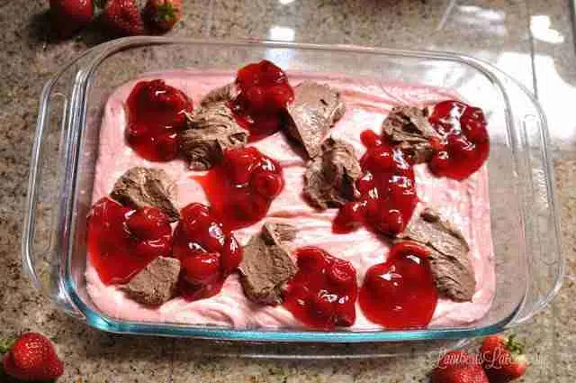 chocolate icing and strawberry pie filling spooned over strawberry cake mix.