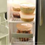 Frozen make-ahead Instant Pot meals in containers in a freezer.