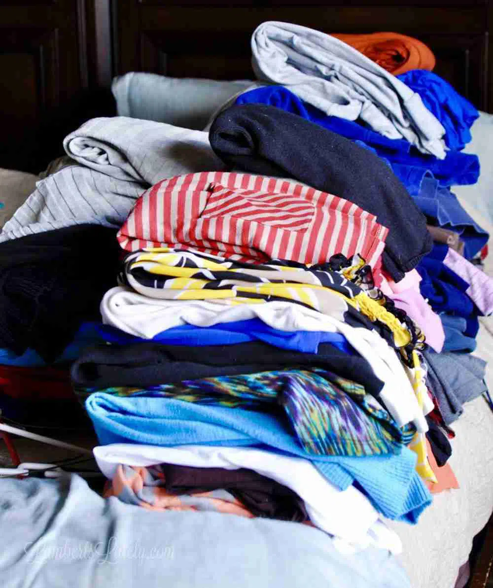 clothes folded on a bed.