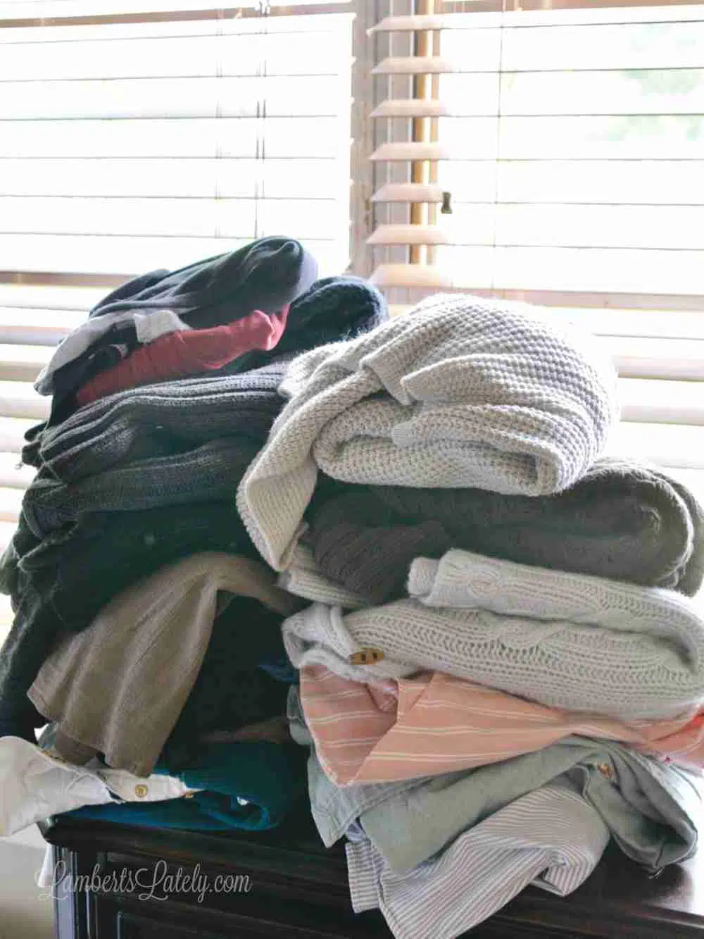 clothes folded in front of a window.