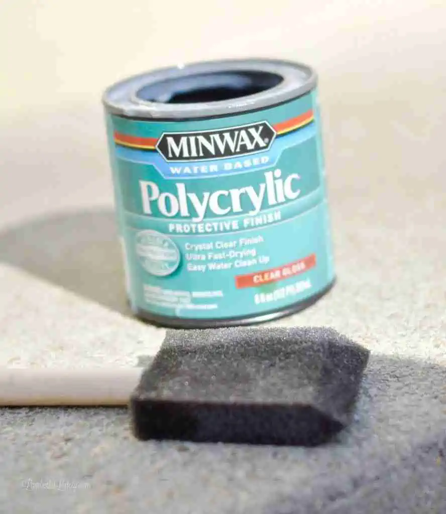 can of polyurethane next to a foam brush.