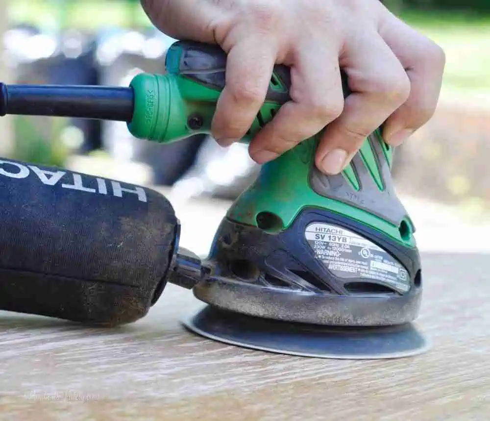 orbital sander on a piece of wood.