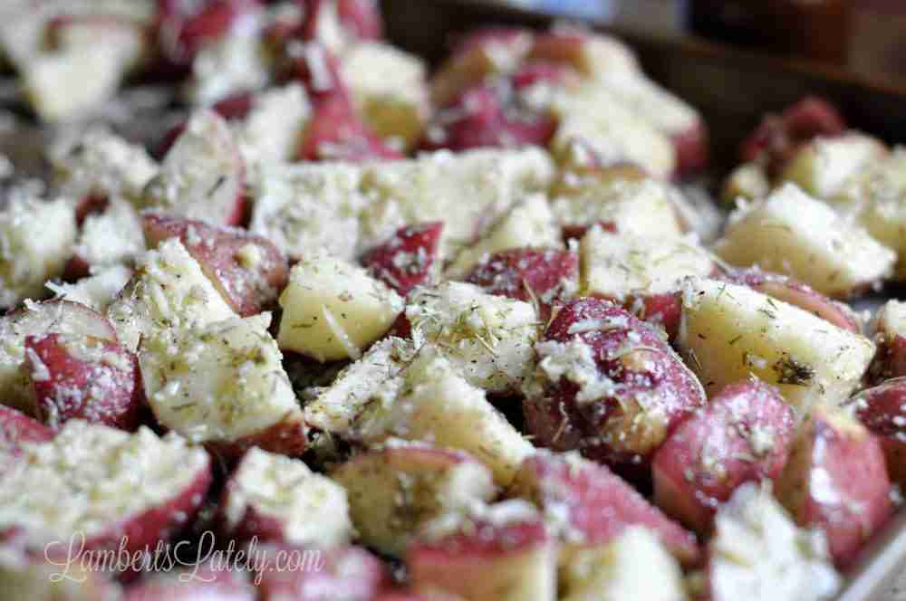 close up of potatoes covered in rosemary and parmesan cheese