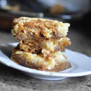 salted caramel chess squares stacked on a plate.