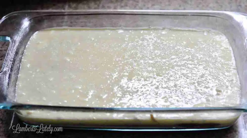 cake batter spread in a glass baking dish.
