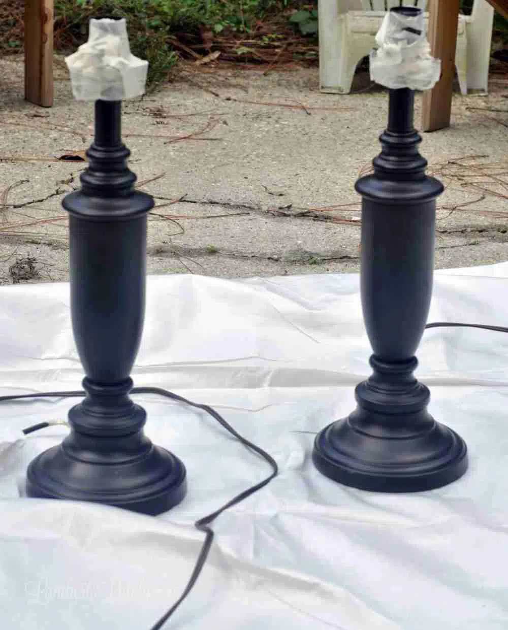 two lamp bases with top taped off.