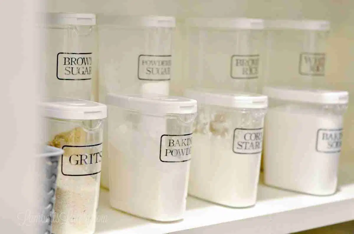 clear plastic canisters on a pantry shelf.