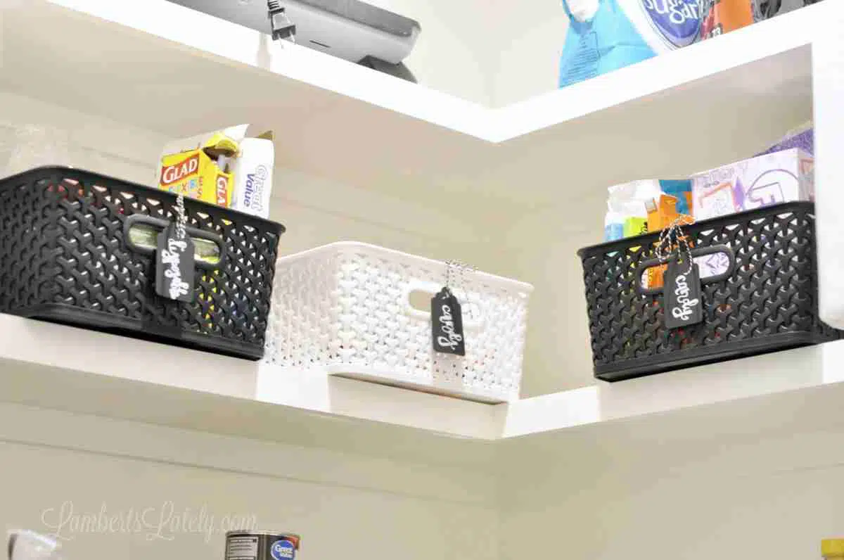 black and white plastic bins on a shelf.