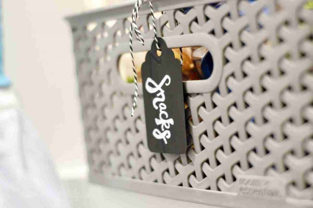 sweets chalkboard tag on a gray plastic bin.