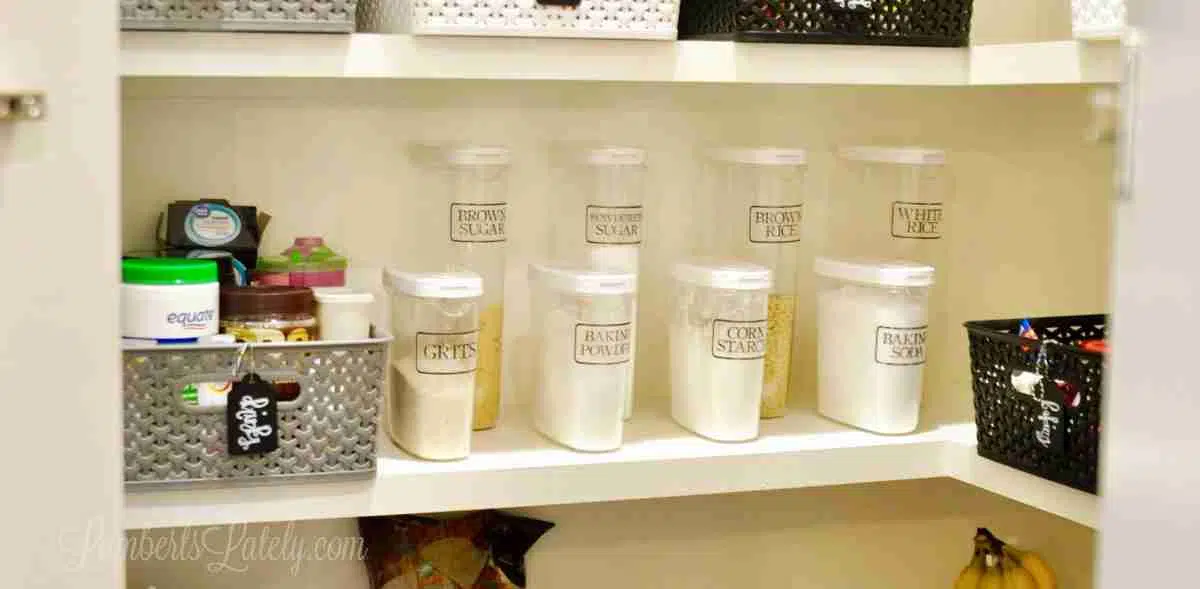 clear plastic canisters on a pantry shelf.