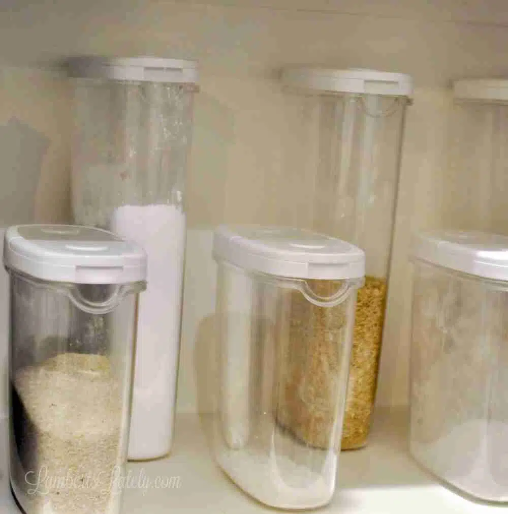 clear pantry canisters on a pantry shelf.