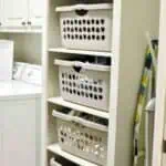 Organized laundry storage with white baskets in a laundry room.