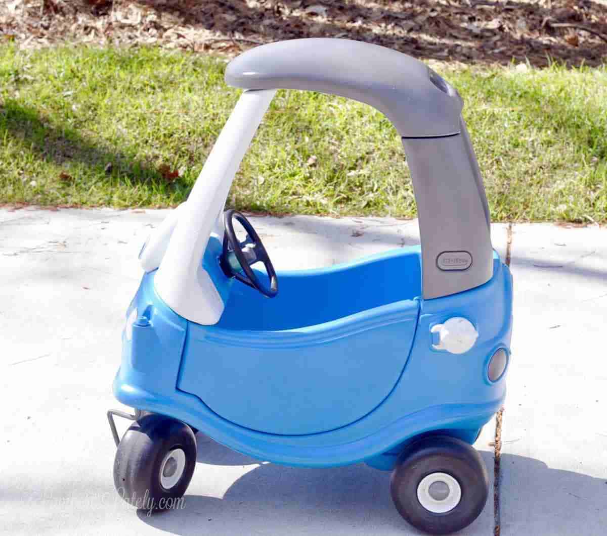 side profile of a blue and gray cozy coupe.