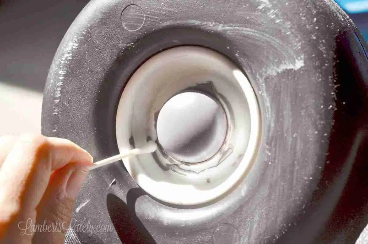 using a q tip to clean up paint around wheel.