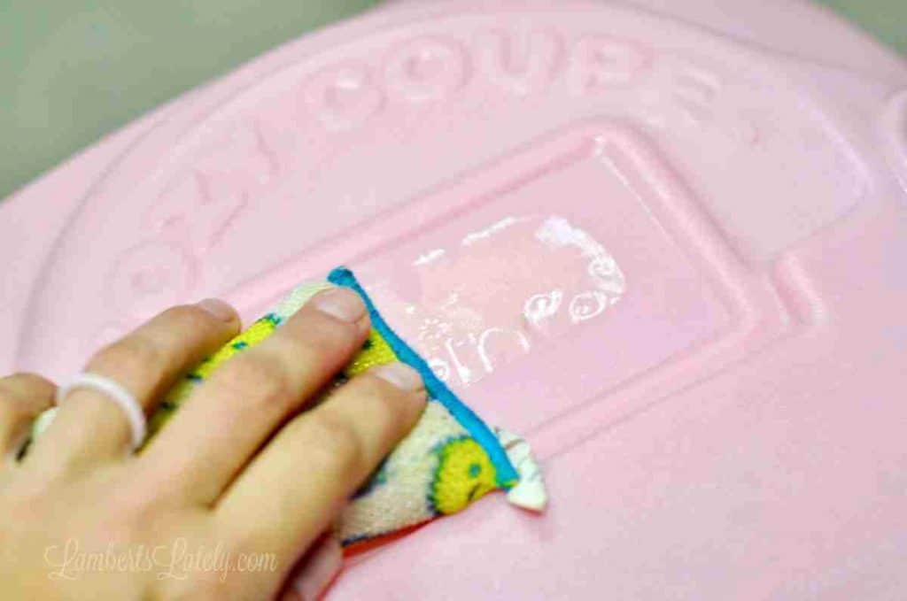 using a sponge to clean decal off of cozy coupe.