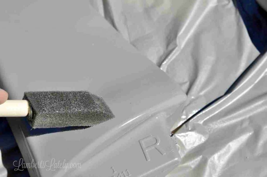 using a sponge brush to even out paint splotches.