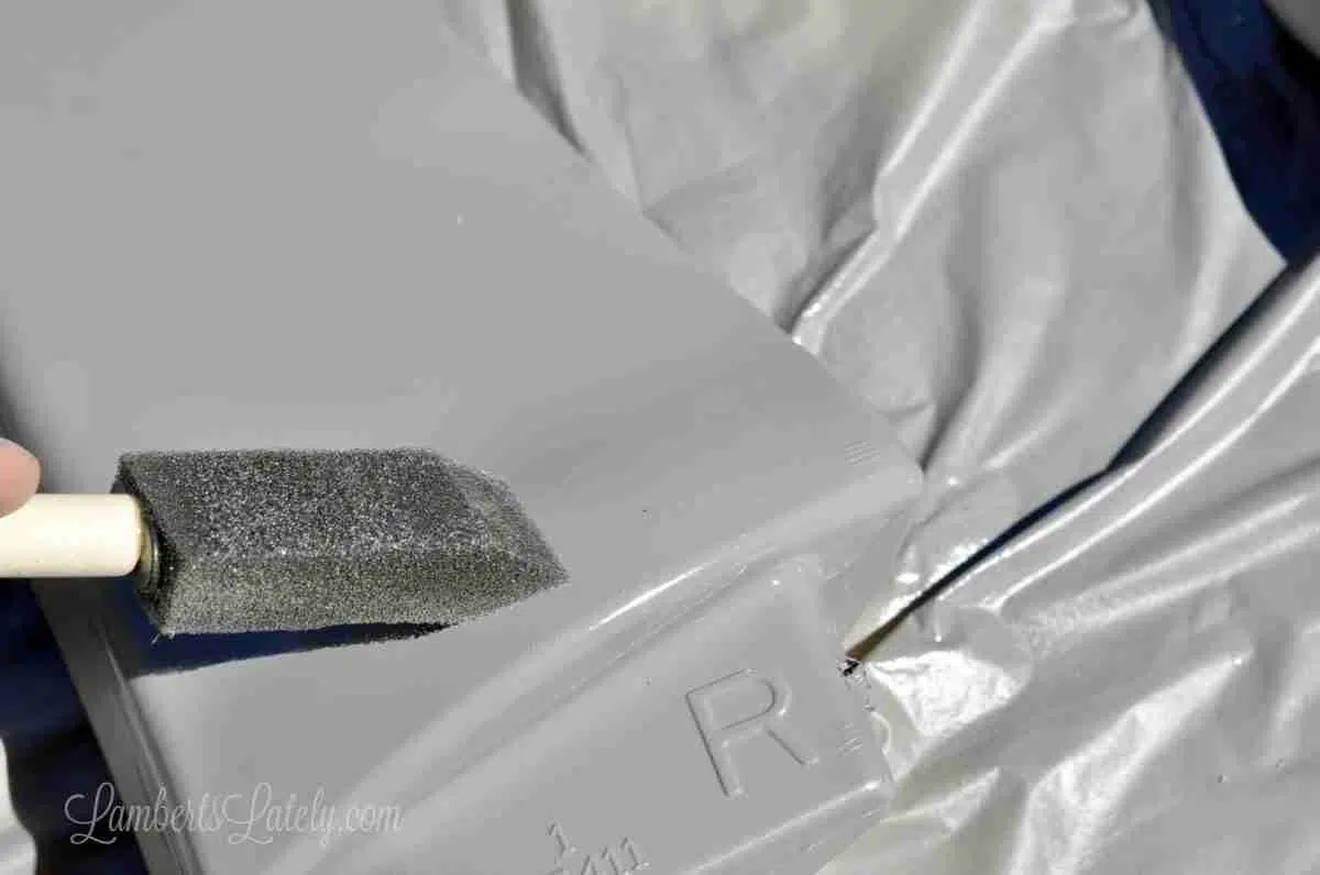 using a sponge brush to even out paint splotches.