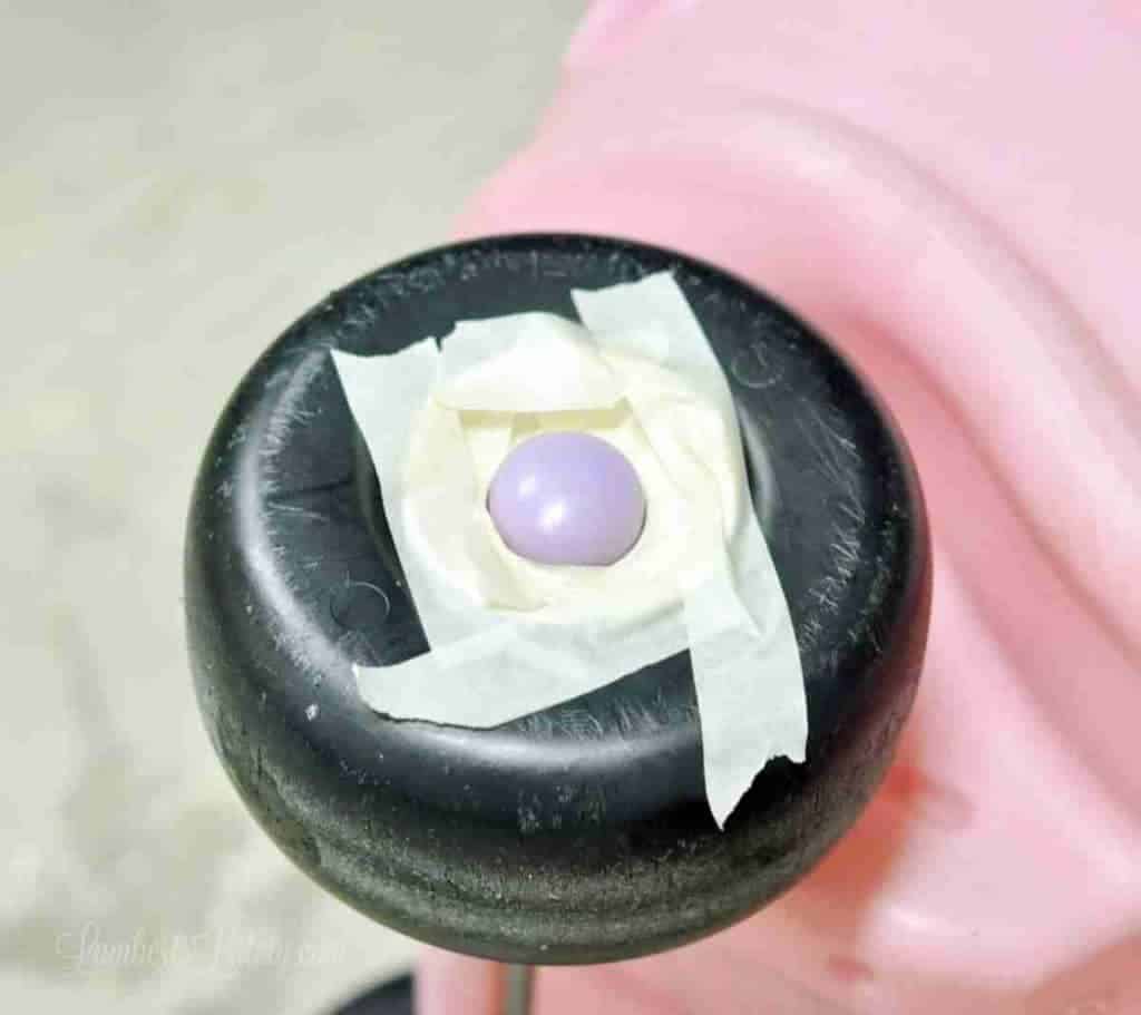 wheel of cozy coupe with center part of wheel taped off.