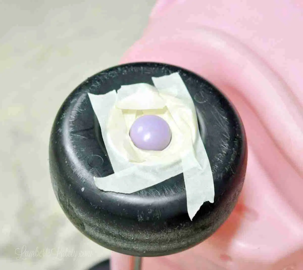 wheel of cozy coupe with center part of wheel taped off.