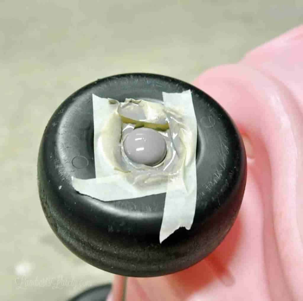 wheel of cozy coupe with center part of wheel taped off and painted.