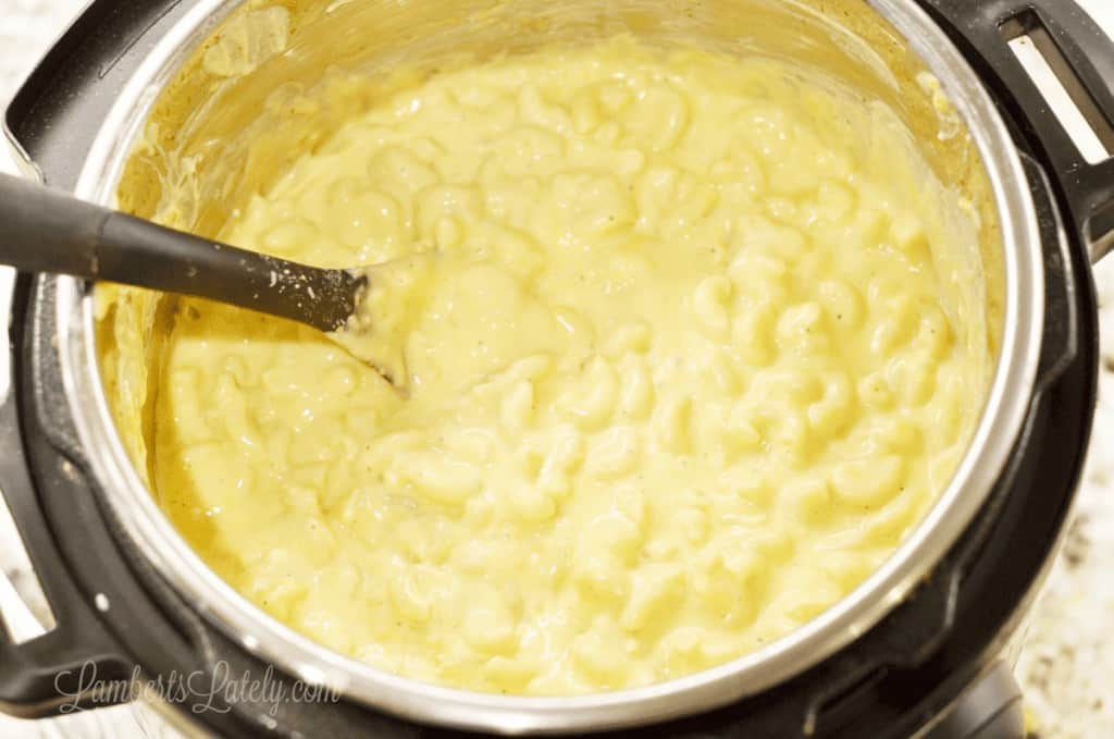 mac and cheese being stirred in an Instant Pot.