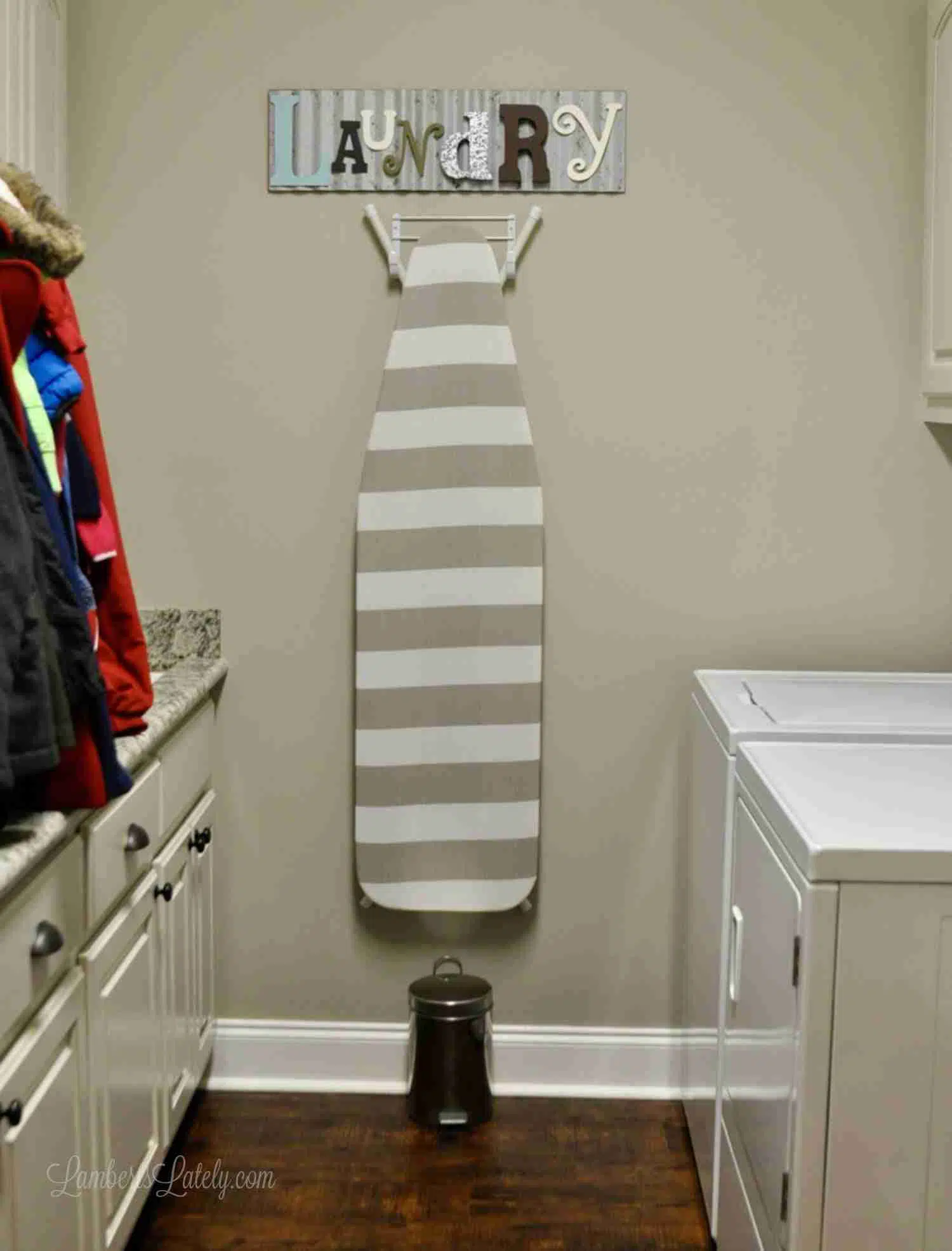 ironing board hanging in a laundry room.