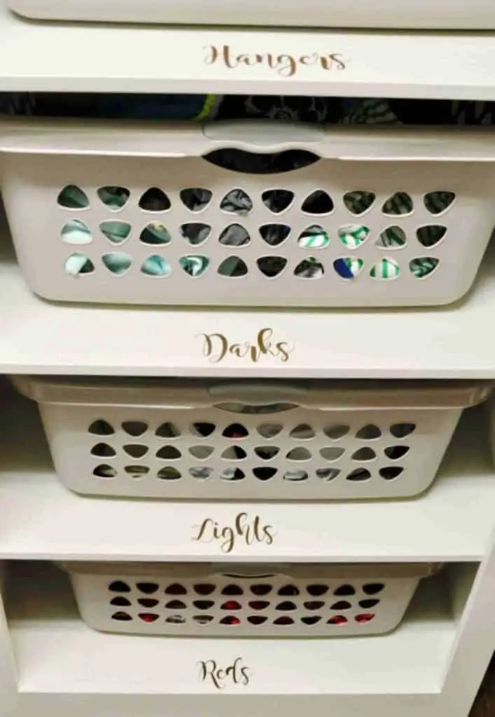laundry baskets stacked in a cabinet, with labels in front.