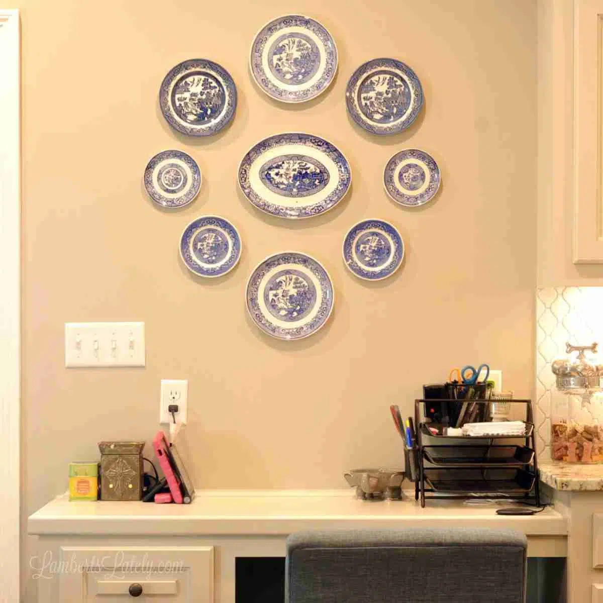 blue and white plates hanging above a desk.