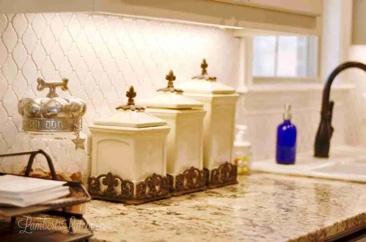beige and bronze kitchen canisters on a countertop.