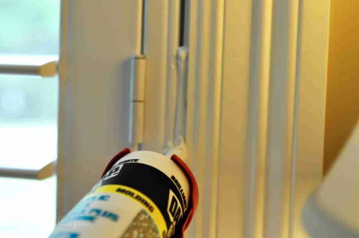caulking gap between plantation shutter frame and window frame.