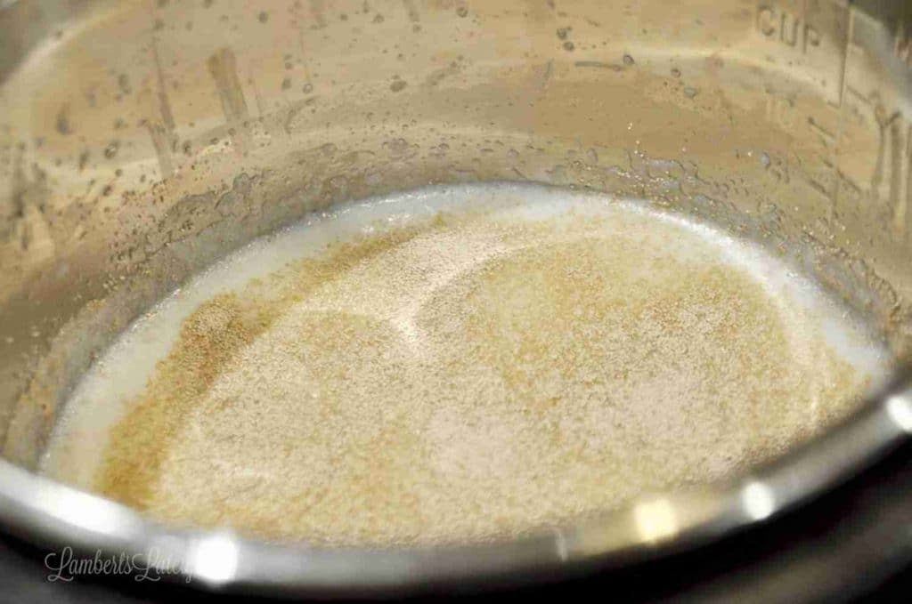 Close-up of a mixture in a mixing bowl for cinnamon rolls with cream cheese frosting.