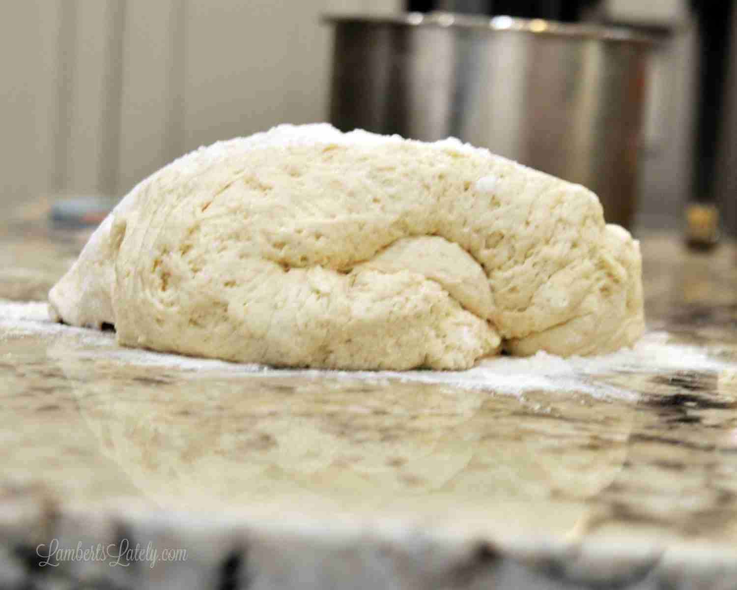 cinnamon roll dough on a floured counter