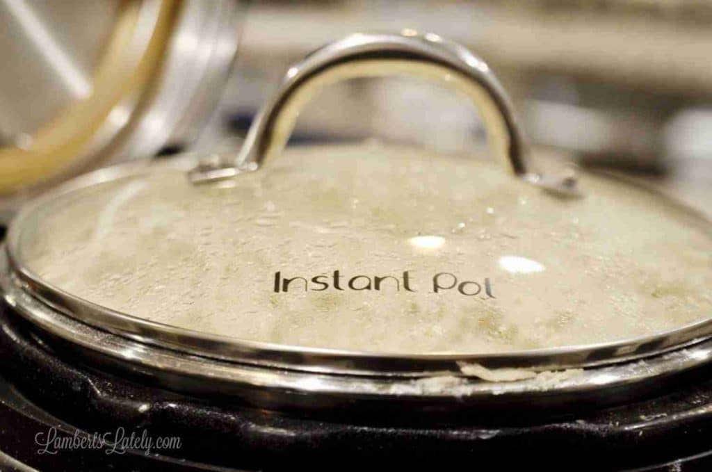 Close-up of a glass lid on an instant pot, with steam inside.