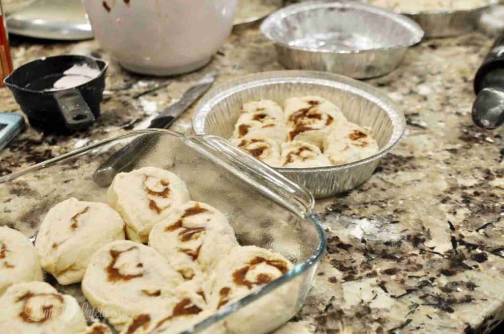 cut cinnamon rolls in baking dishes.