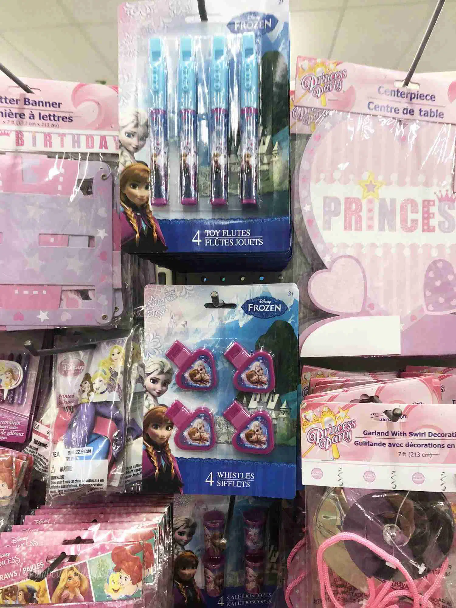 princess party supplies hanging on a shelf at a store.