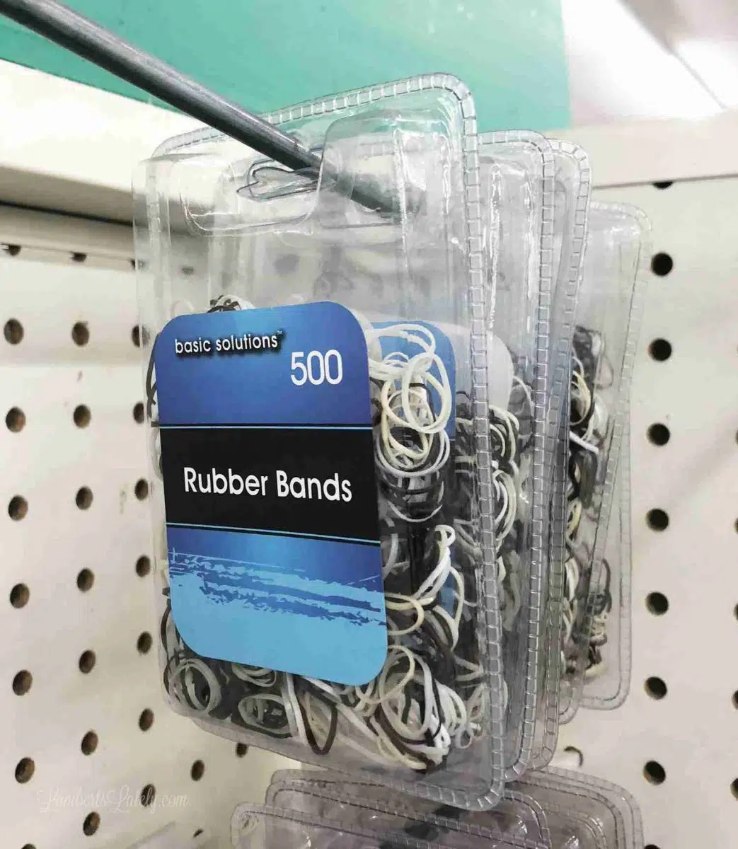 rubber bands hanging on a shelf at dollar tree.