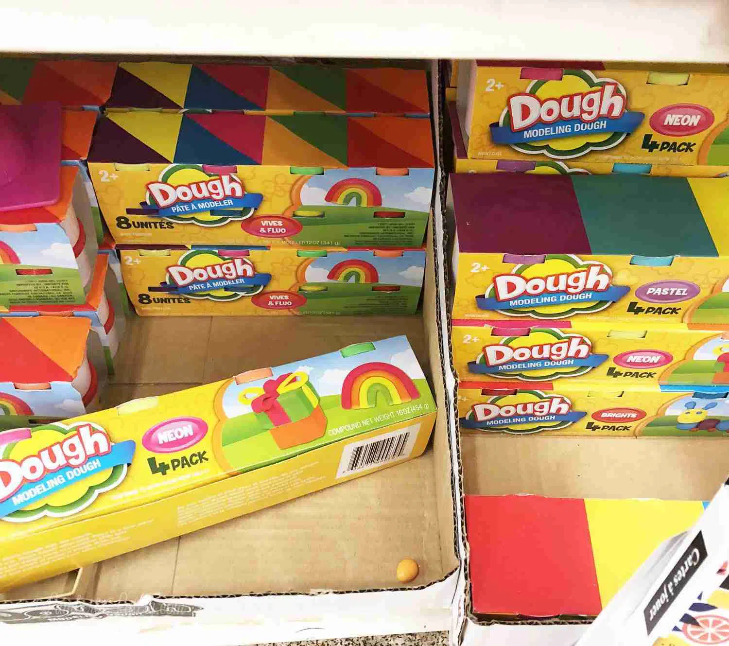 play dough on a shelf at a store.
