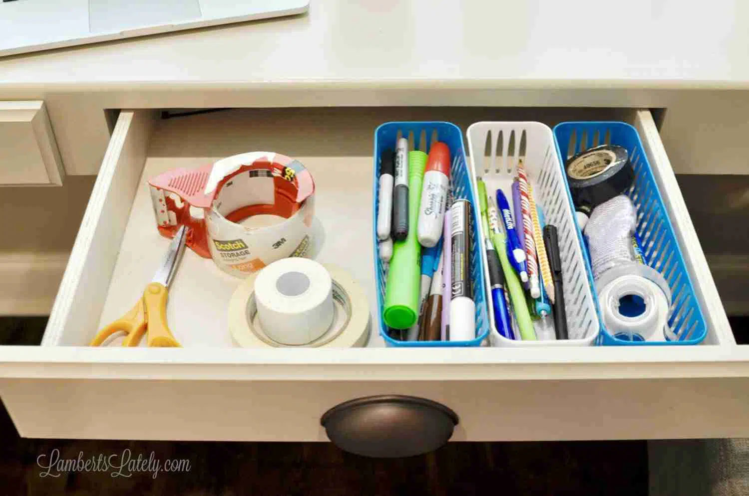 office supplies in a drawer.