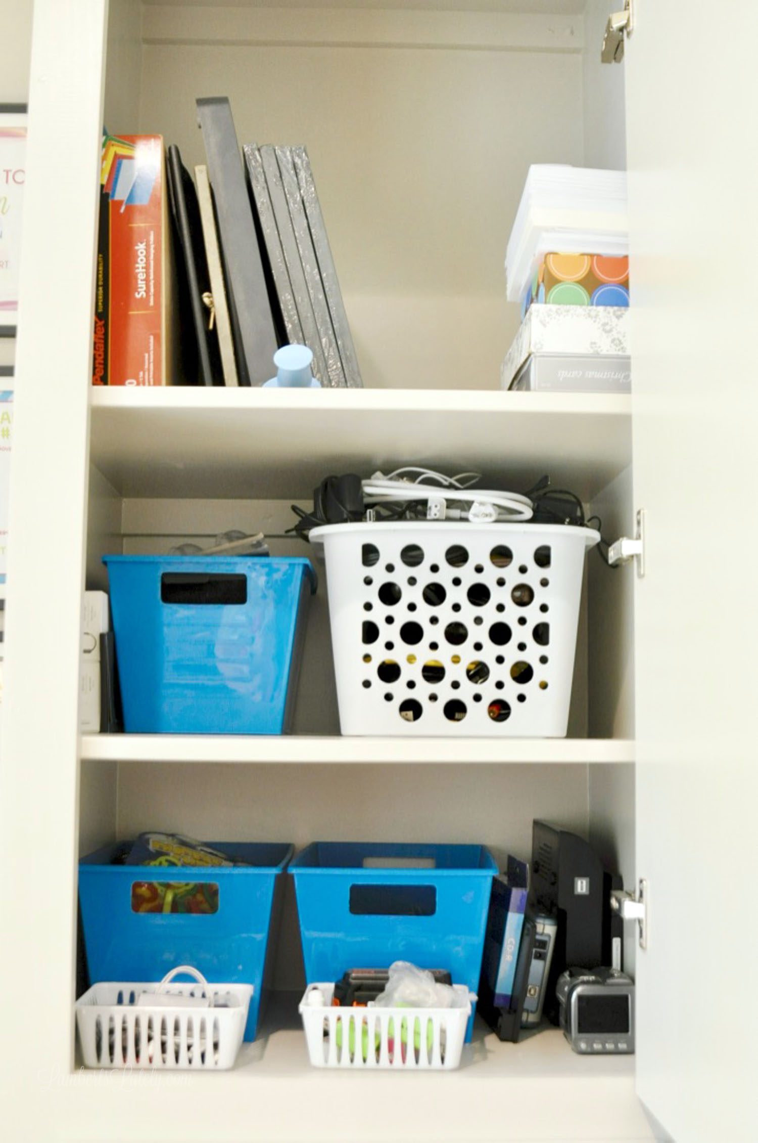plastic organizers in a shelf.