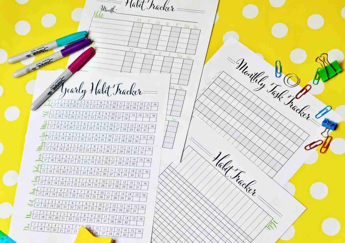 set of 4 habit tracker printable pages on a yellow polka dot background