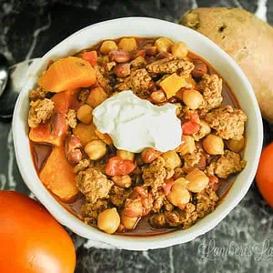 looking down on a bowl of turkey chili topped with sour cream.