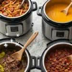 Instant Pot freezer meal prep session with various cooked dishes and herbs.