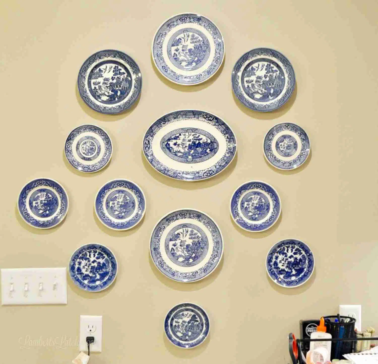 blue willow plates hanging above a desk.