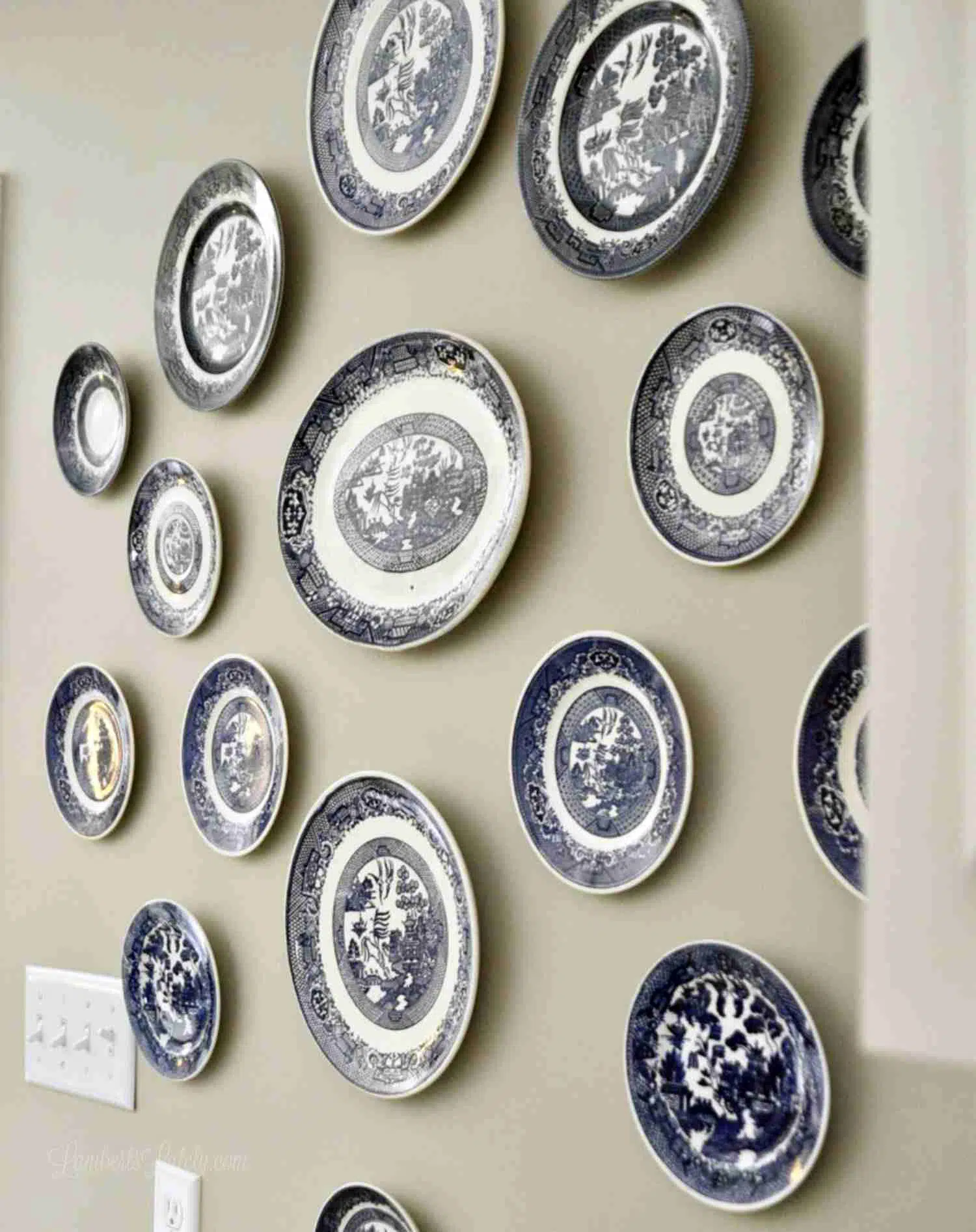 blue and white plates hung on a wall.