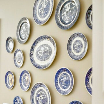 blue and white plates hanging on a wall.